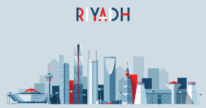 Abstract illustration of the Riyadh skyline featuring iconic structures like the Kingdom Centre Tower, Al Faisaliyah Centre, and Riyadh TV Tower. The image presents a blend of traditional and modern architectural elements in shades of blue, white, red, an