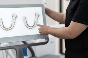 An orthodontist presenting an orthodontic solution using intraoral scans during a consultation.