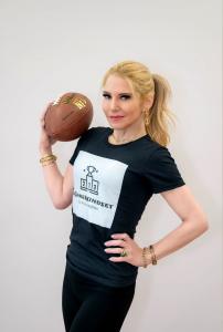 Woman in #GameMindset t-shirt holding a football