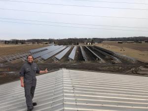 Adam Schaller on his plant roof with solar panels