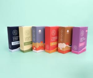 colorful herbal tea folding cartons on a green background