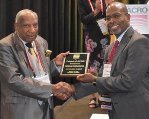 Dr. Suthanthiran accepts Friend of ACRO award from ACRO President, Dwight E. Heron.