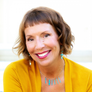Dr. Nasha Winters, smiling, in a yellow cardigan