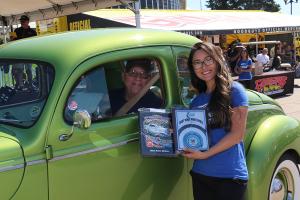 An award is given to a happy car owner during the Goodguys North Carolina Nationals.