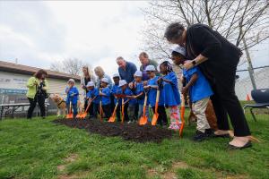 Children breaking ground on a new outdoor play area for Capital Area Head Start
