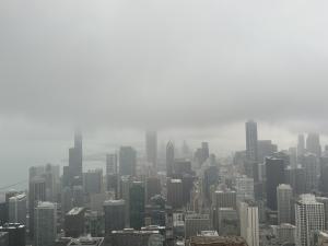 Clouds and fog add a mystical touch to the Chicago skyline viewed from the John Hancock Building, an image presented by AWSCWI.COM.