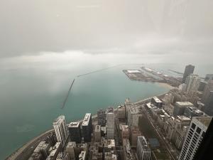 The mesmerizing Chicago skyline unfolds beneath the gaze from the John Hancock Building, presented by AWSCWI.COM