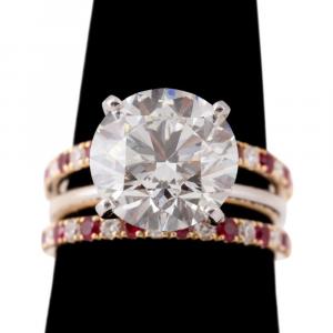 Diamond and ruby wedding ring set, boasting a 6.85-carat round brilliant cut diamond (VS-2 clarity and I color), flanked by ruby and diamond bands in 18k yellow gold (est. $90,000-$135,000).