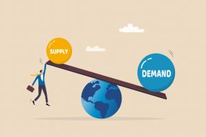 businessman holding seesaw balance of demand and supply on the globe.