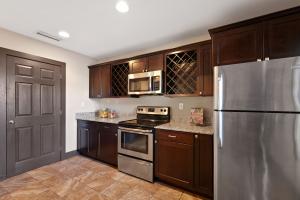 The modern kitchens include granite countertops, new stainless steel appliances, modern lighting, and new tile floors.