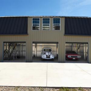 An image of a multi-bay garage with classic cars parked inside.