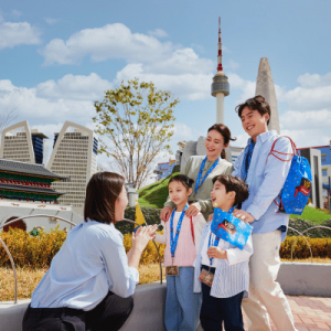A family four interacting with a staff from LEGOLAND Korea Resort.