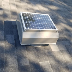 Solar attic fan on a roof