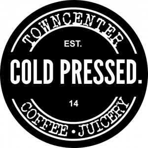 A black circular logo with white lettering that reads "Town Center" rounded off on top with "COLDPRESSED" in bold lettering at the center with the words "Coffee" & "Juicery" rounded off underneath.
