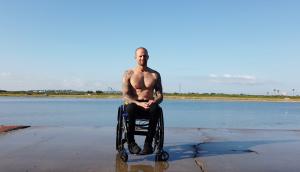 David Charbonnet shirtless in wheelchair at kayak club