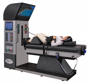 DRX9000 Lumbar Spinal Decompression Machine with patient laying on it being treated.