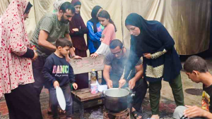 Mohammed’s family is seen cooking together in a basic setup, a testament to their enduring spirit and the human aspect of the crisis.