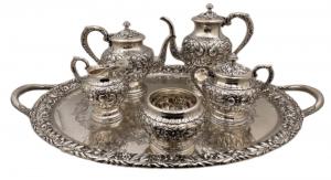 S. Kirk & Son sterling silver repousse six-piece tea and coffee set with tray, all matching and richly adorned with crisp floral motifs, in pattern #474F from 1932 (est. $9,000-$12,000).