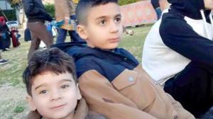 Two young boys, Mohammad and Qais, looking hopeful against a backdrop of uncertainty.