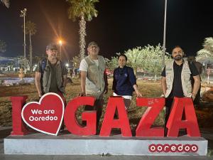 Images of 4 IMANA doctors in front of the I "heart" Gaza sign.