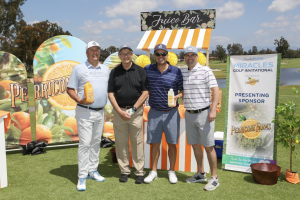 4 golf players standing in front of the Perricone Farms Comfort Station, their names are:Bob Rovzar, Dr. Mike Rovzar, Jim Davenport, and Andy Rovzar