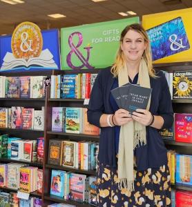 Alysha Scarlett poses at Barnes & Noble with three copies of her book, "'Star Wars' Is Still Intact: Re-finding Yourself in the Age of Trump." The book is being sold by the bookstore.