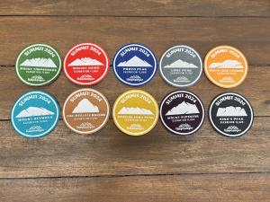 The ten summit badges offered by Timpanogos Hiking Co. for 2024