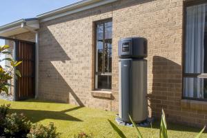 Installation of a modern heat pump hot water system in an Australian home, eligible for the NSW Rebate and Victorian Rebate programs.