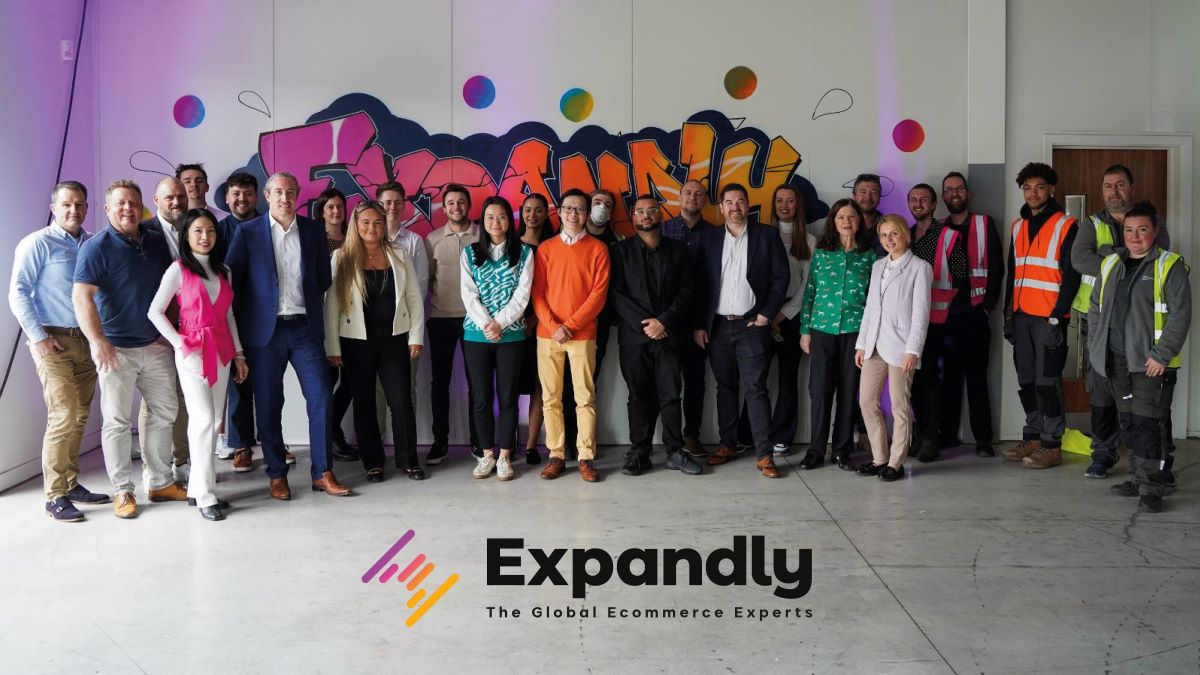 Expandly Team Gather Together In Front Their Graffiti Feature Wall