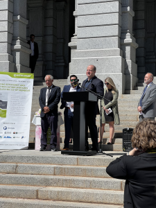 Governor Polis speaking at the Colorado State Capitol.