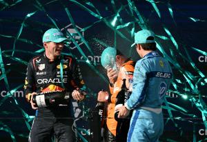 Three racecar drivers celebrate the Formula 1 wins