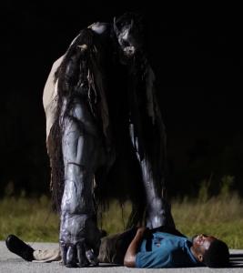 La Patasola monster stands over the actor, Patrick Walker ("James").