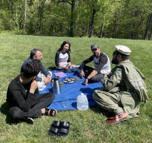 The Black Feather Foundation Founder, Joseph Robert III and CEO Patti Katter engage in heartfelt dialogue with Afghan refugee community leaders over a cup of tea.