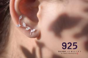 phoenix manufacturing sterling silver jewelry in woman's ear