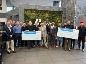 Robert Alvine and the Team at Premier Subaru Dealerships present a checks for over $147k to Camp Rising Sun