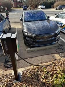 A picture of an EV charger on a pedestal.