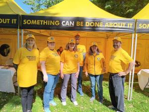This is a photo of volunteer ministers at their yellow tent at Kids Day