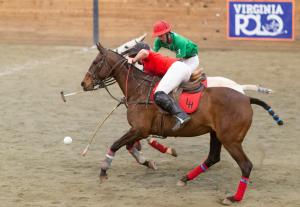 Two collegiate men's arena polo players fight for the ball in National Intercollagiate Championship