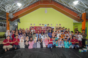 Group photo of EBC employees, orphans, and staff members from Nurul Ibad Child Welfare Institution.