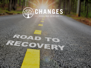A highway with the word recovery shows the concept that treating underlying causes of addictive behaviors is essential for recovery success