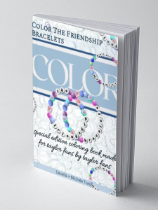 Color the Friendship Bracelets 6 x 9" coloring book for adults standing up. The book shows its depth of 198 pages. The book has a light blue and white cover with multicolored friendship bracelets spelling out words.