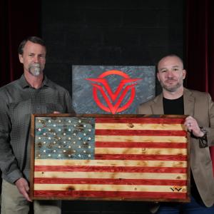 Warriors Heart Co-Founder/President and Delta Operator Tom Spooner presents former Navy SEAL, CIA Contractor and Vigilance Elite Founder Shawn Ryan with a Warriors Heart flag that was handmade by warriors at their healing center.