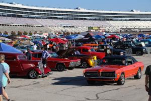 Packed speedway infield with classic cars