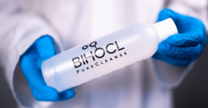 BIHOCL PureCleanse held by a medical professional wearing nitrile gloves