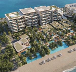 Aerial drone view of Ela Residences with pool and sea view surrounding the complex