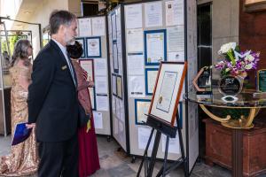 Guests looking at proclamations and awards recognizing L. Ron Hubbard and the Writers and Illustrators of the Future.