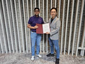 Actxa CEO, Marcus Soo and Dr Abhinav standing together, holding the MOU