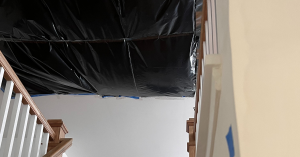 Large hole in ceiling tarped to prevent mold spores from dropping