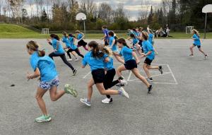 Girls joining a program by Fit Girls of Wilton Maine race across a basketball court.