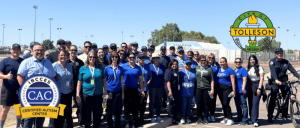 City of Tolleson staff wearing blue shirts gathered in a parking lot.